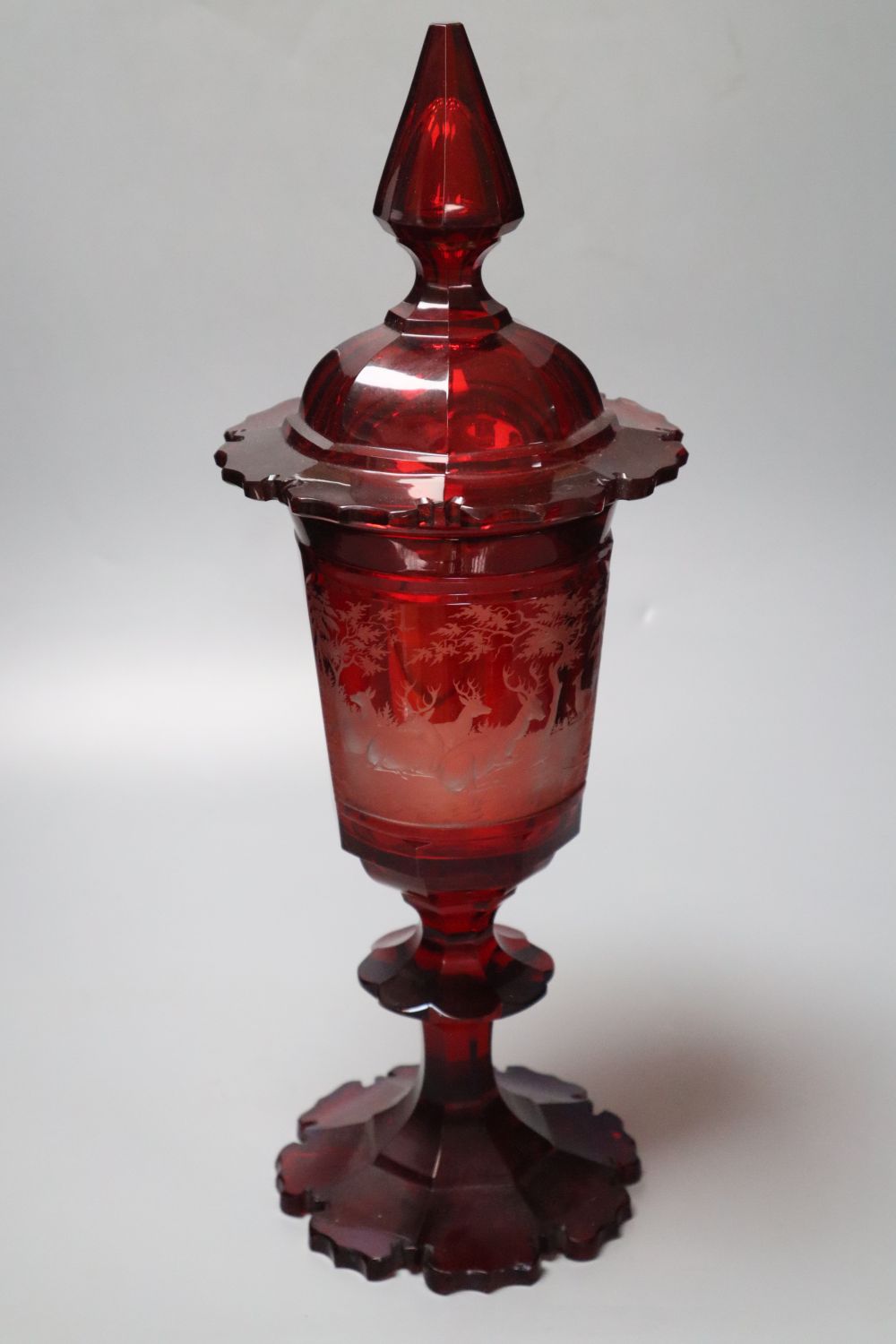 A large Bohemian wheel engraved ruby flash glass vase and cover decorated with deer, late 19th century, 43.5cm